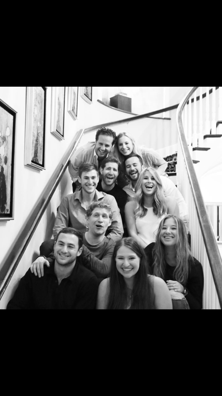 The cousins together, gathered on a staircase
